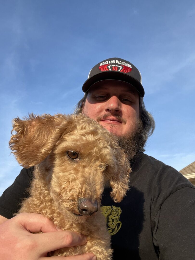 Man with Goldendoodle Dog