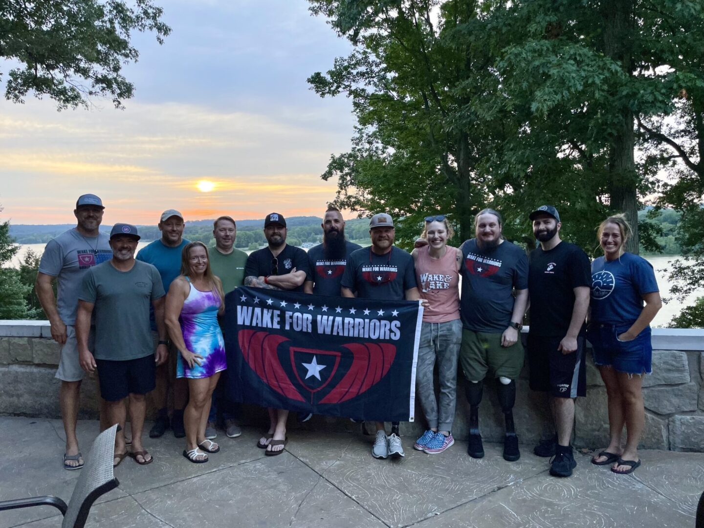 Group holding "Wake for Warriors" banner outdoors.