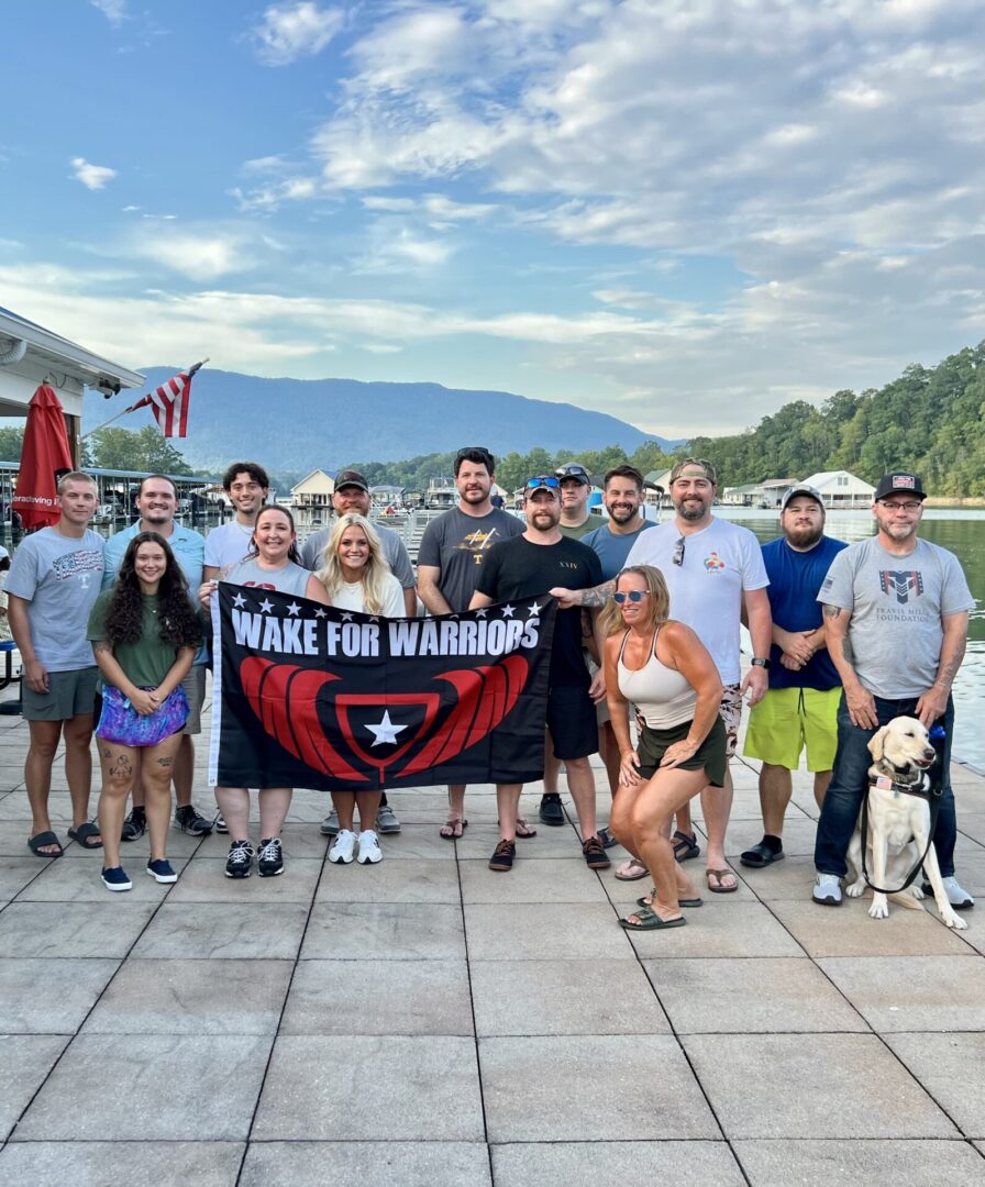 Group holding "Wake for Warriors" banner outdoors.