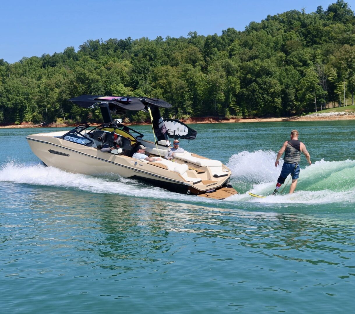 Man wakesurfing behind a boat on lake.