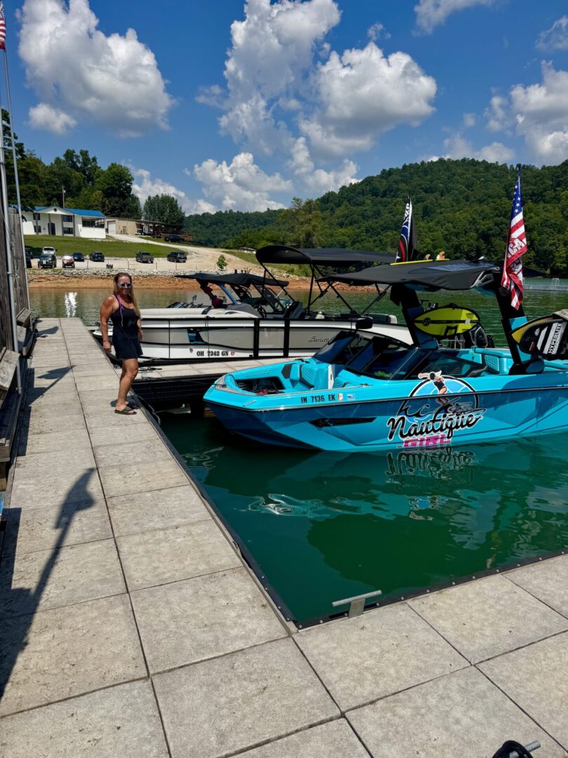 Person standing by boats on a dock.